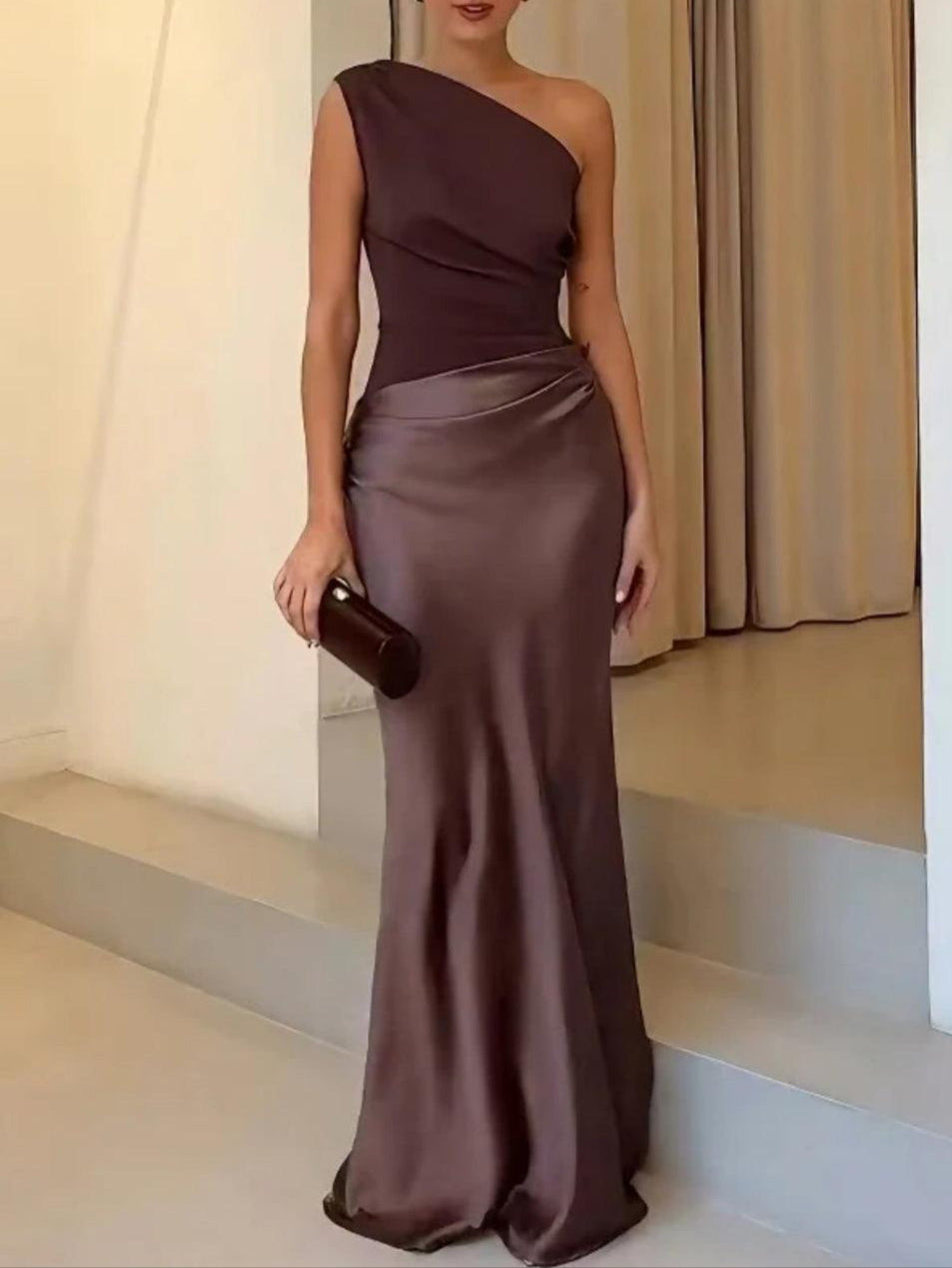 Long asymmetrical evening gown with off-the-shoulder design and elegant pleats