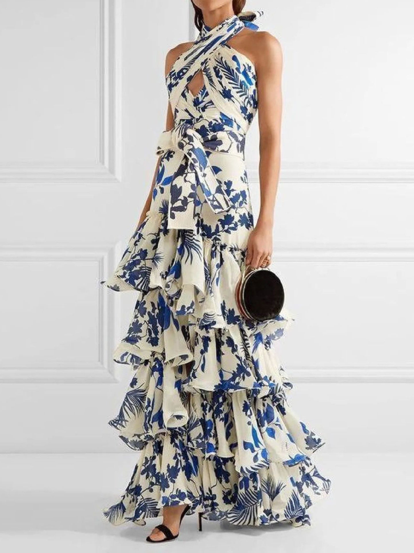 Blue and white floral maxi dress with halter neckline, open back, and elegant ruffles