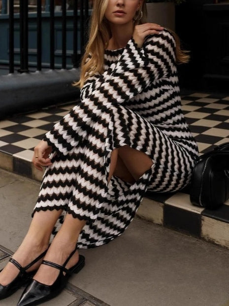 Knit dress with round neckline, asymmetrical and elegant with slit detail for a trendy look