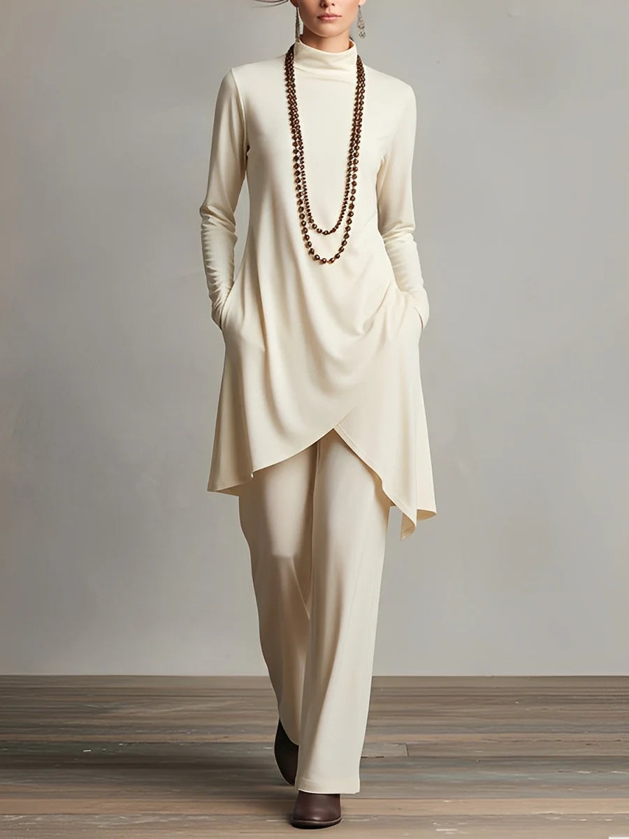 Elegant high-neck top with an asymmetric hem, paired with sleek trousers – a chic set