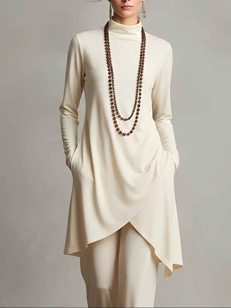 Elegant high-neck top with an asymmetric hem, paired with sleek trousers – a chic set