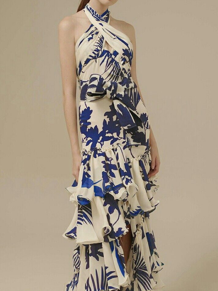 Blue and white floral maxi dress with halter neckline, open back, and elegant ruffles