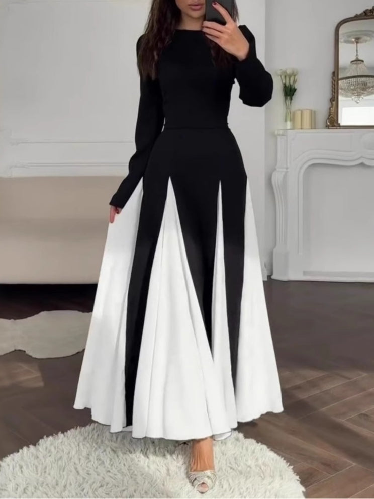 Elegant black and white dress with a round collar, cinched waist, and long sleeves